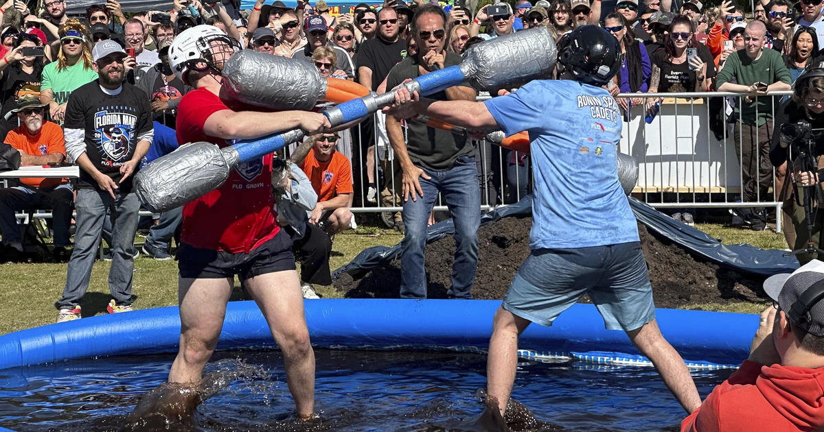 At the Florida Person Games, significant crowds cheer competition evading law enforcement, wrestling about beer