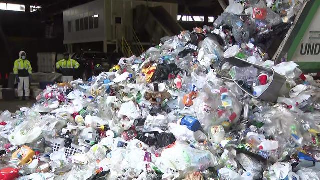 A pile of recyclable plastic is dumped in a New York facility. 