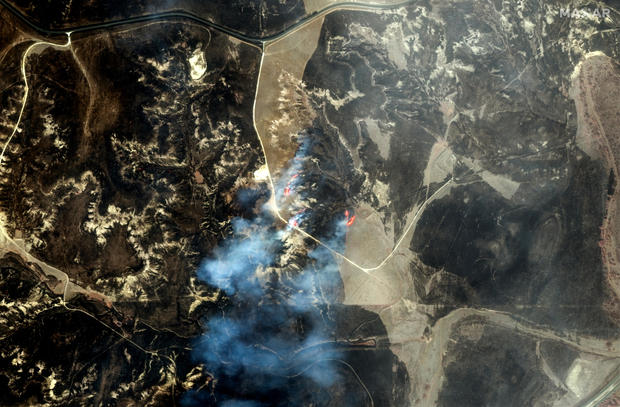 An infrared satellite image shows a fire line and burn scars west of Miami, Texas, Feb. 28, 2024. With color infrared imagery, burned vegetation appears in shades of black and gray. 