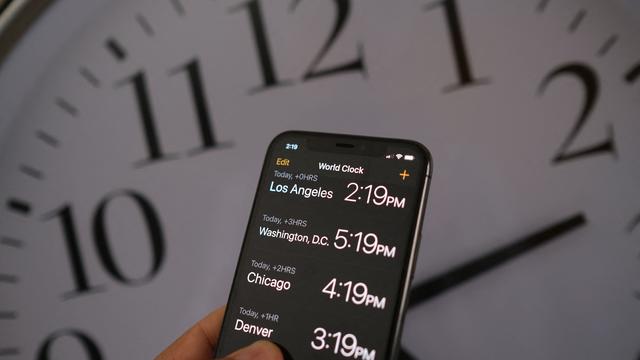 Time on a phone and a clock 