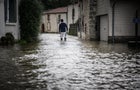 A man walks down a flooded street in France 