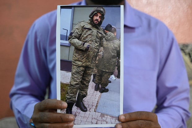 Mohammed Imran shows a picture of his brother Mohammed Asfan along the Russian border with Ukraine, at their home in Hyderabad, India, on Feb. 22, 2024.