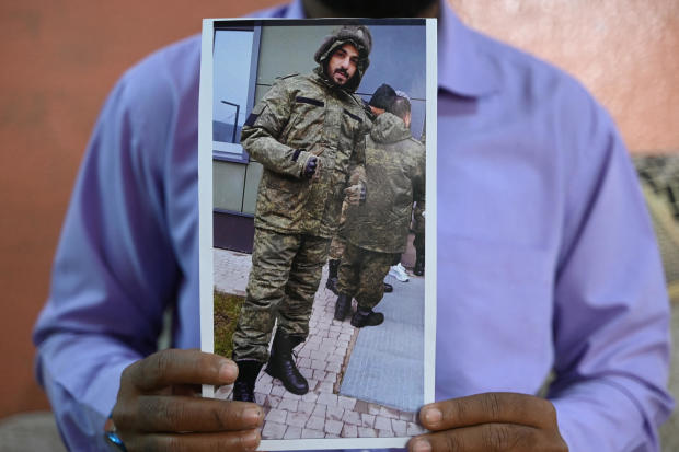 Mohammed Imran shows a picture of his brother Mohammed Asfan along the Russian border with Ukraine, at their home in Hyderabad, India, on Feb. 22, 2024. 