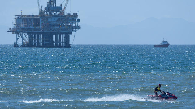 Roughly 2.5-mile-long oil slick was spotted today off the coast of Huntington Beach, but its source remained unclear. According to the Coast Guard, the slick is about 1.5 miles off the coast 