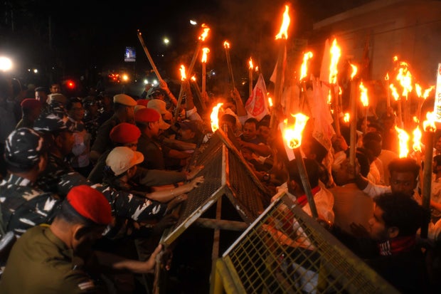 Indian security personnel try to stop activists of the All Assam Students Union (AASU) during a protest march after the central government implemented the Citizenship (Amendment) Act in Nagaon district, Assam, India