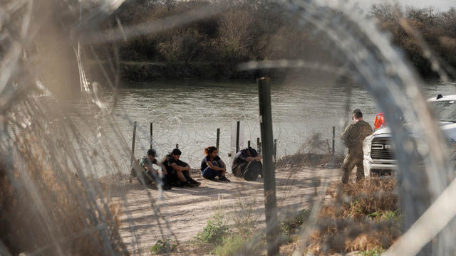Border patrol officers pull barbed wires as migrants cross the Rio Grande river to surrender to the American authorities in Ciudad Juárez, Mexico, on March 7, 2024. 