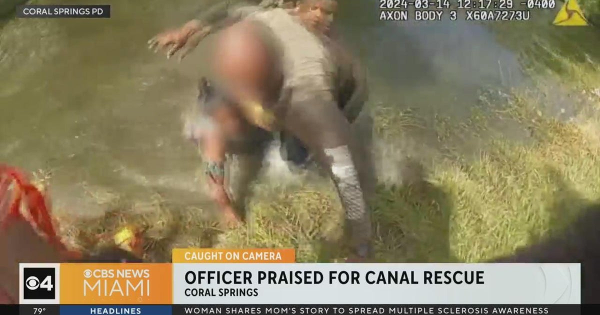 Caught on camera: Police rescue 2 people trapped inside submerged car ...