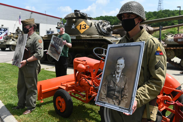 Photos of "ghost soldiers" who took part in deceptive maneuvers on D-Day in Normandy, France in 1944 are displayed in Old Bethpage, New York on June 6, 2020. 