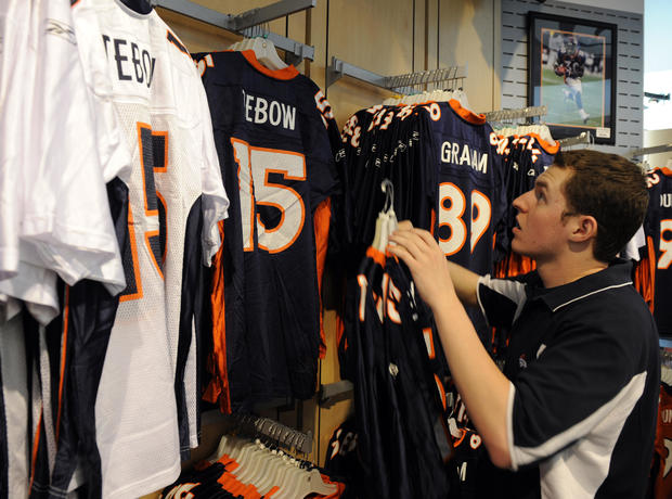 DENVER,CO--APRIL 28TH 2010--Matt Wiessenberger, retail associate for the Broncos Team Store at Invesco field at Mile High, hangs newly acquired Denver Bronco, Tim Tebow jerseys on the rack Wednesday afternoon. Andy Cross, The Denver Post 