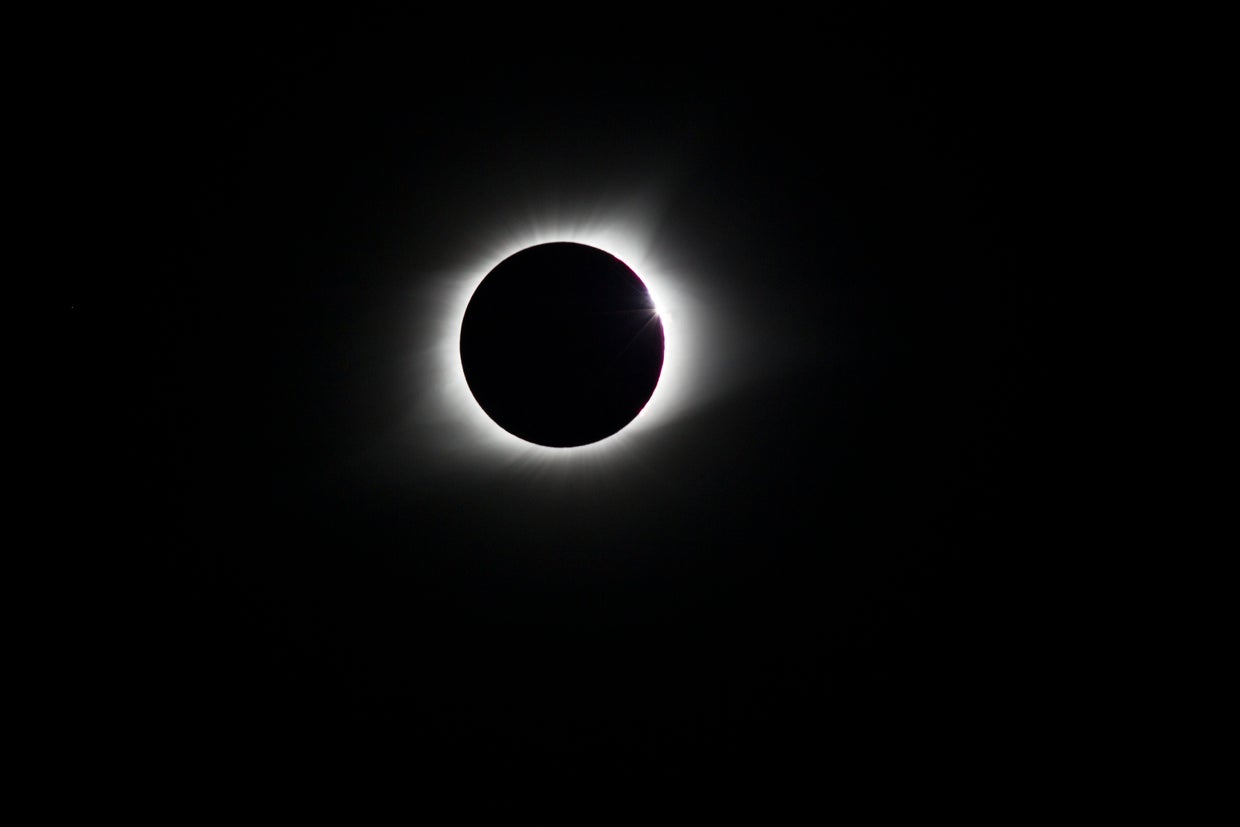 The total eclipse of the sun. The rays of light appear as