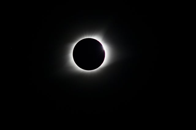 The total eclipse of the sun. The rays of light appear as 