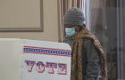 A voter takes a sticker after casting an early ballot at a polling station on Thursday, Feb. 9, 2023, in Milwaukee. 