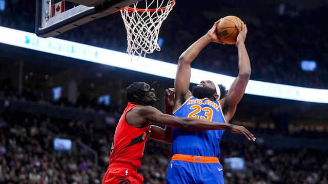 Mitchell Robinson #23 of the New York Knicks goes to the basket against Mouhamadou Gueye #16 of the Toronto Raptors during the first half of their basketball game at the Scotiabank Arena on March 27, 2024 in Toronto, Ontario, Canada. 