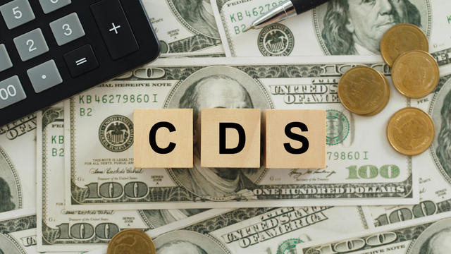 text CDS wrote on wooden cubes On top of the dollar bills. It is an abbreviation for credit default swap. a financial derivative that allows an investor to swap his credit risk.credit default swap 