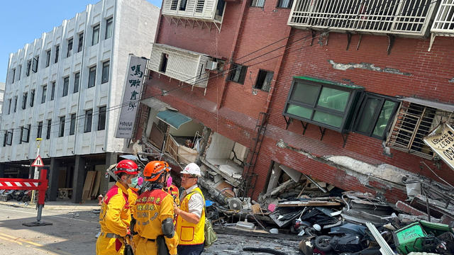 Firefighters work at the site where a building collapsed following the earthquake, in Hualien 