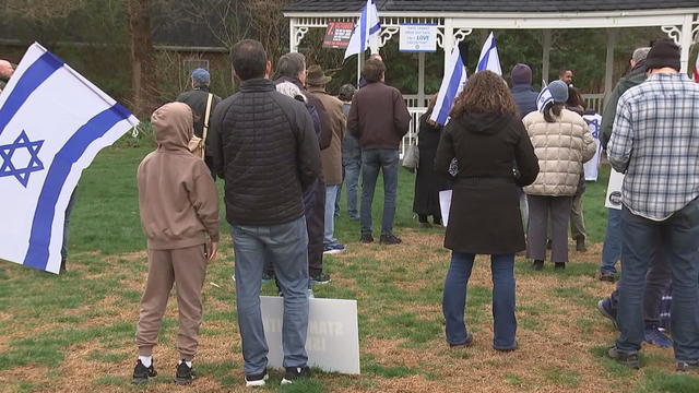 About 100 people gathered at the Bryn Mawr Gazebo, some holding Israeli flags and posters 
