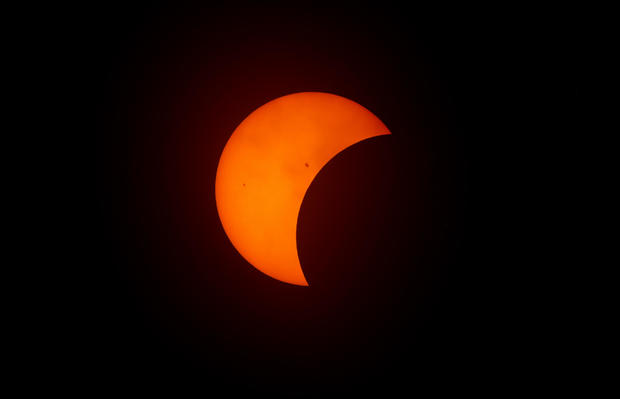 The moon begins to eclipse the sun on April 8, 2024, in Fort Worth, Texas. 