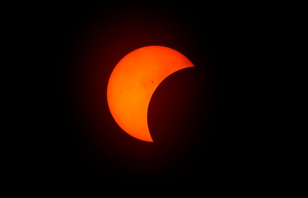 The moon begins to eclipse the sun on April 8, 2024, in Fort Worth, Texas.