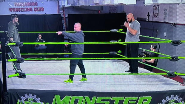 Jason Kelce and Lane Johnson in the ring with a trainer at Monster Factory 
