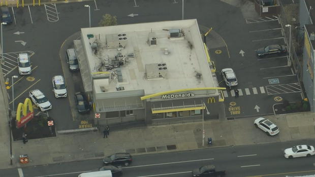 An aerial shot of a McDonald's, several police cars are in the parking lot around the restaurant 