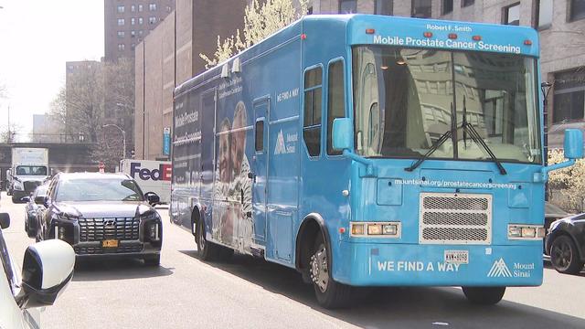 The Mount Sinai Robert F. Smith Mobile Prostate Cancer Screening Unit drives down a street. 