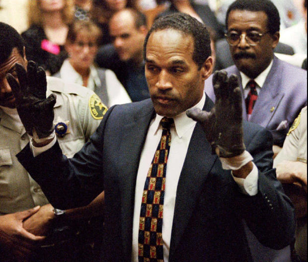 O.J. Simpson, wearing the blood-stained gloves found by the LAPD during testimony in his murder trial 