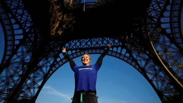 Athlete Anouk Garnier celebrates the world record for rope climbing on the Eiffel Tower in Paris 