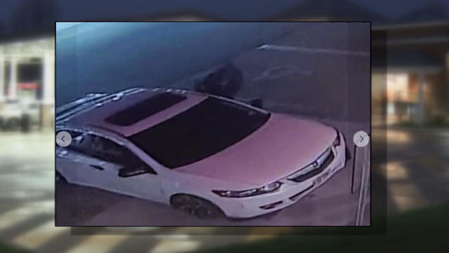 A white Acura is seen on surveillance footage 