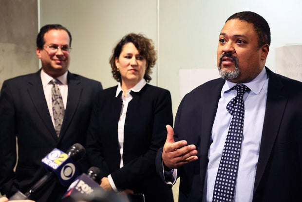 Prosecutors Joshua Steinglass and Susan Hoffinger listen as Manhattan District Attorney Alvin Bragg gives a brief comment on Dec. 6, 2022, in New York City.
