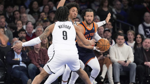 New York Knicks guard Jalen Brunson (11) is defended by Brooklyn Nets forward Trendon Watford (9) and forward Jalen Wilson during the first half of an NBA basketball game Friday, April 12, 2024, at Madison Square Garden in New York. 