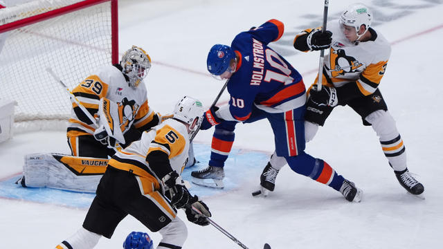 New York Islanders Right Wing Simon Holmstrom (10) takes a shot on Pittsburgh Penguins Goalie Alex Nedeljkovic (39) with Pittsburgh Penguins Defenseman Jack St. Ivany (3) defending during the first period of the National Hockey League game between the Pit 