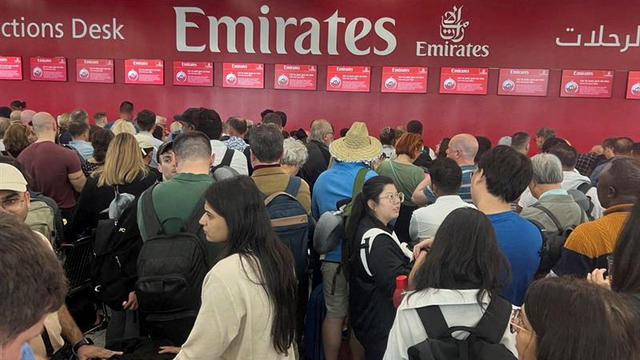 People queue at a flight connection desk after a rainstorm hit Dubai, causing delays at the Dubai International Airport 