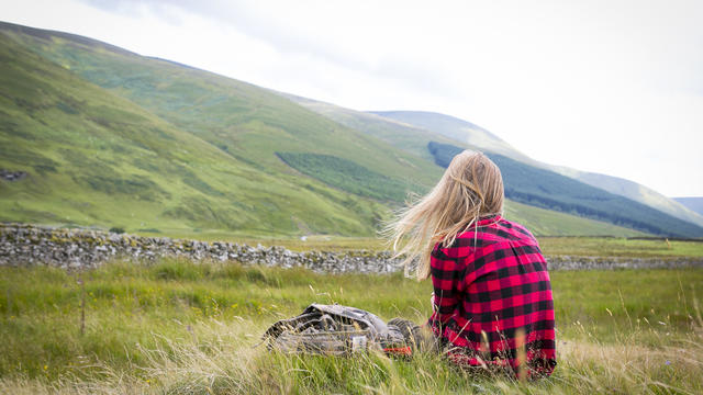 Girl enjoying the view in Scottish hilly landscape 