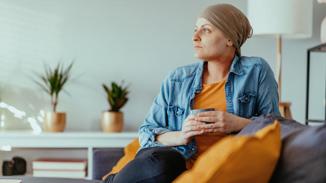 Cancer patient looking far, wearing headscarf 