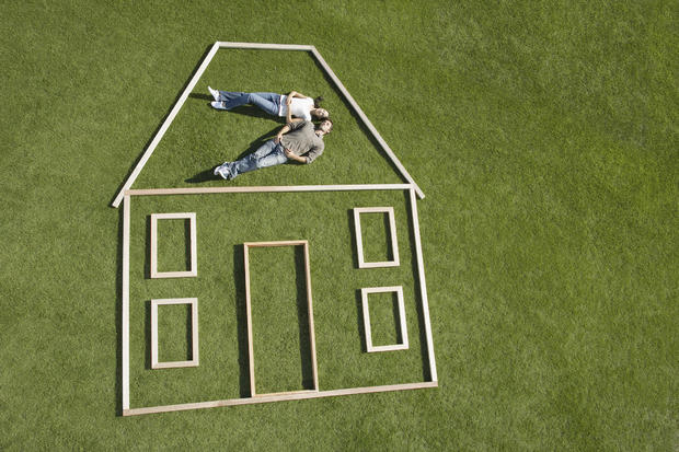 Couple laying inside house outline 