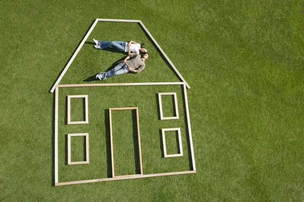 Couple laying inside house outline