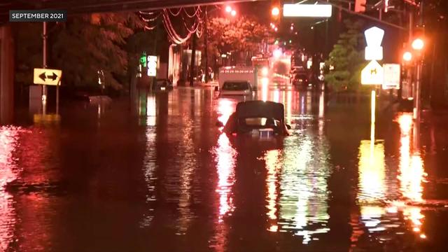 Vehicles are submerged in flood waters in on a Passaic, New Jersey street. 