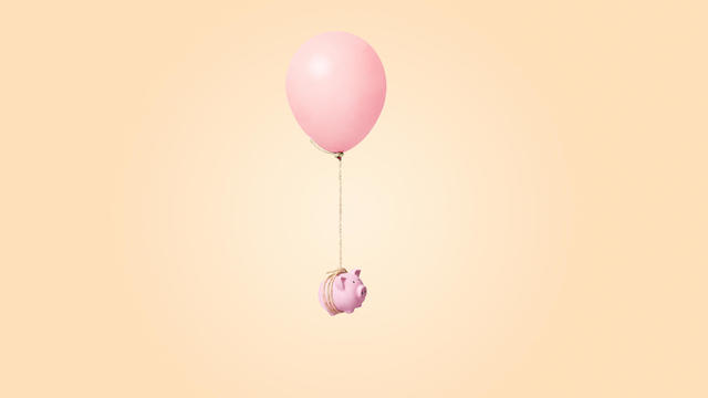 pink piggy bank tied to a balloon 