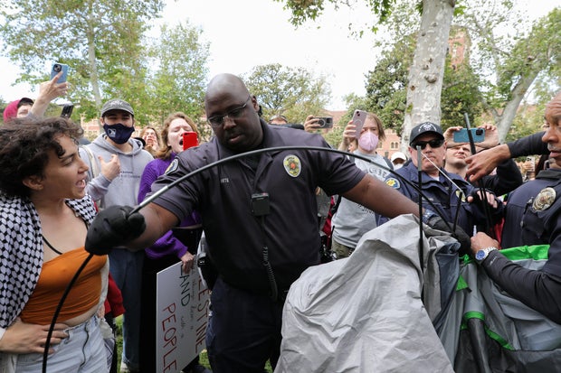 University of Southern California safety officers try to disperse students protesting Israel's war in Gaza, at the school's Alumni Park in Los Angeles, California, April 24, 2024. 