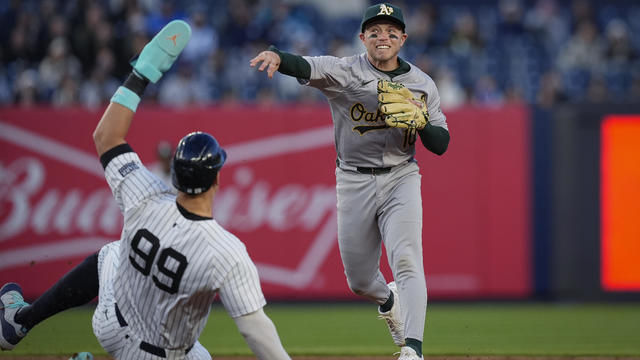 Oakland Athletics shortstop Nick Allen throws to first base for the double play after forcing out New York Yankees' Aaron Judge (99) during the first inning of a baseball game Thursday, April 25, 2024, in New York. Anthony Rizzo was out at first. 