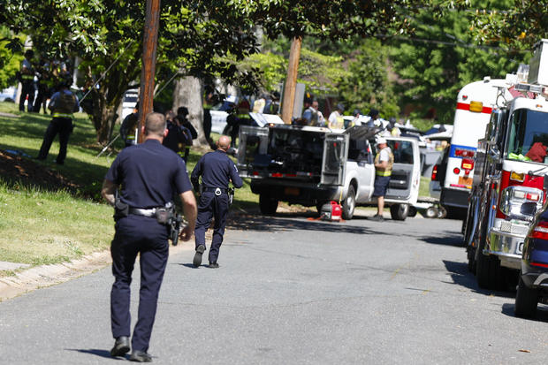 Officers with the Charlotte-Mecklenburg Police Department work in the neighborhood where a shooting took place in Charlotte, North Carolina, April 29, 2024. 