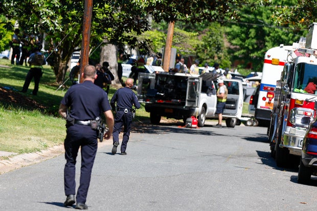Officers with the Charlotte-Mecklenburg Police Department work in the neighborhood where a shooting took place in Charlotte, North Carolina, April 29, 2024.