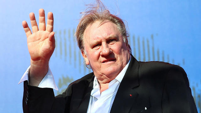 FILE PHOTO: Gerard Depardieu waves as he arrives during a red carpet event for the movie 