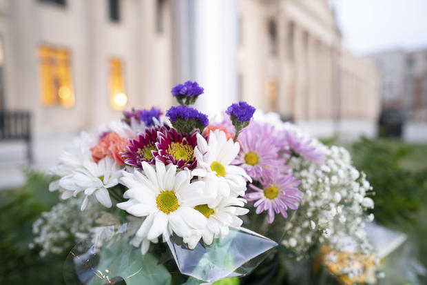 Flowers in memory of fallen law enforcement officers are seen at the base of a flagpole outside the federal courthouse on April 30, 2024, in Charlotte, North Carolina. 