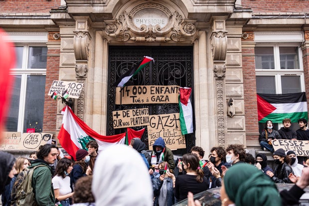 Students block the entrance to the ESJ Higher School of Journalism in Lille, northern France, on May 2, 2024, during a demonstration of pro-Palestinian solidarity amid Israel's war with Hamas in Gaza.