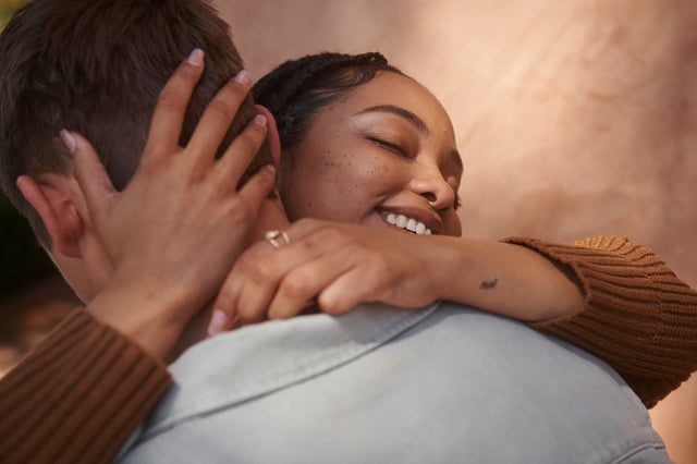 Close-up of young couple hugging. 