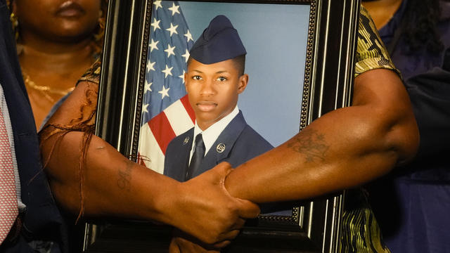 Chantemekki Fortson, mother of Roger Fortson, a U.S. Air Force senior airman, holds a photo of her son during a news conference regarding his death, along with family and attorney Ben Crump, May 9, 2024, in Fort Walton Beach, Florida. 