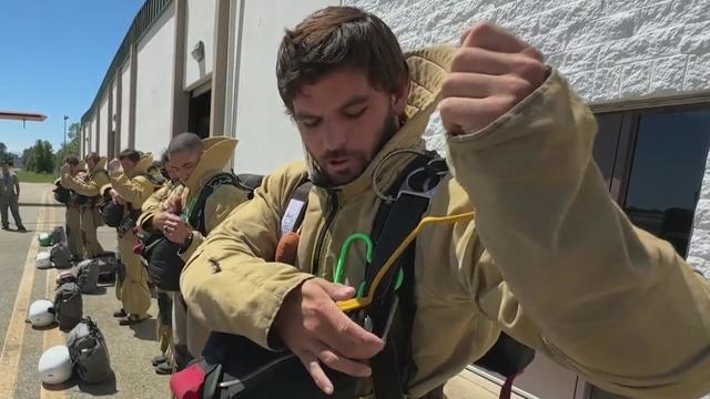 Smokejumpers Getting Ready to Parachute from Plane 