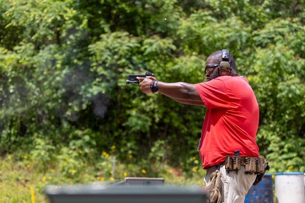 Firearms instructor Larry Brown Jr. uses his gun during target practice at South River Gun Club Inc. in Covington, Georgia, Sunday, May 5, 2024.