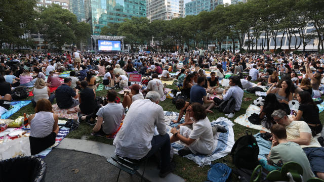 Visitors watch American romantic comedy film, "Roman Holiday" on a big screen during the Bryant Park Summer Film Festival at Bryant Park, in New York, USA, on July 10, 2023. 